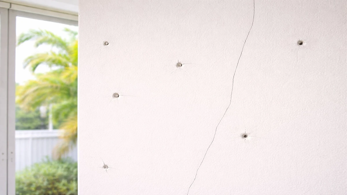 South Florida interior wall showing nail pops and hairline cracks needing drywall repair