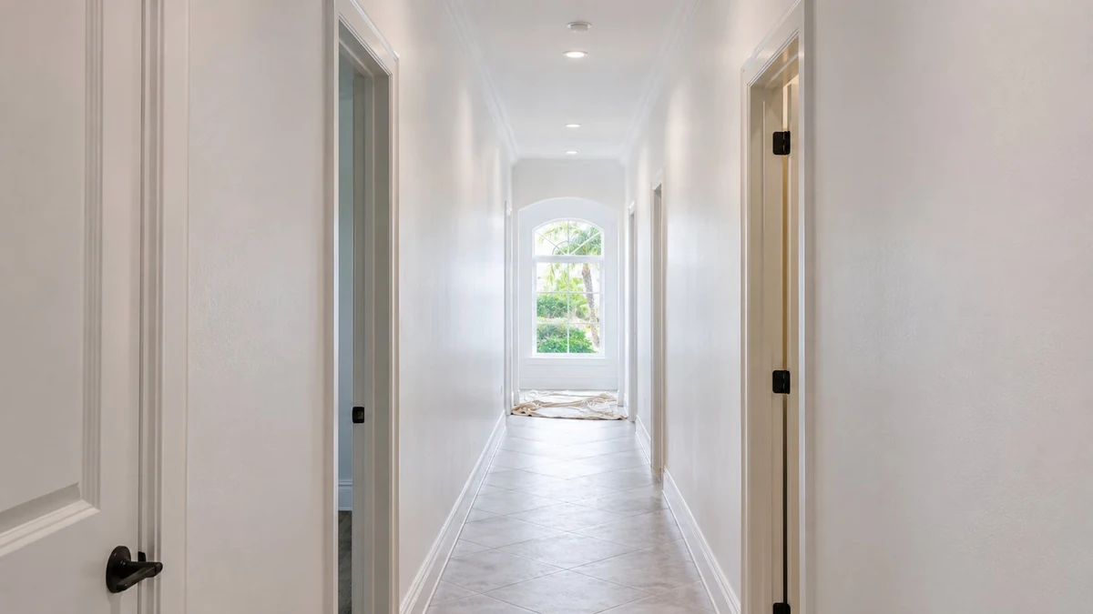 Freshly painted white hallway in a Palm Beach County home with clean trim and natural light